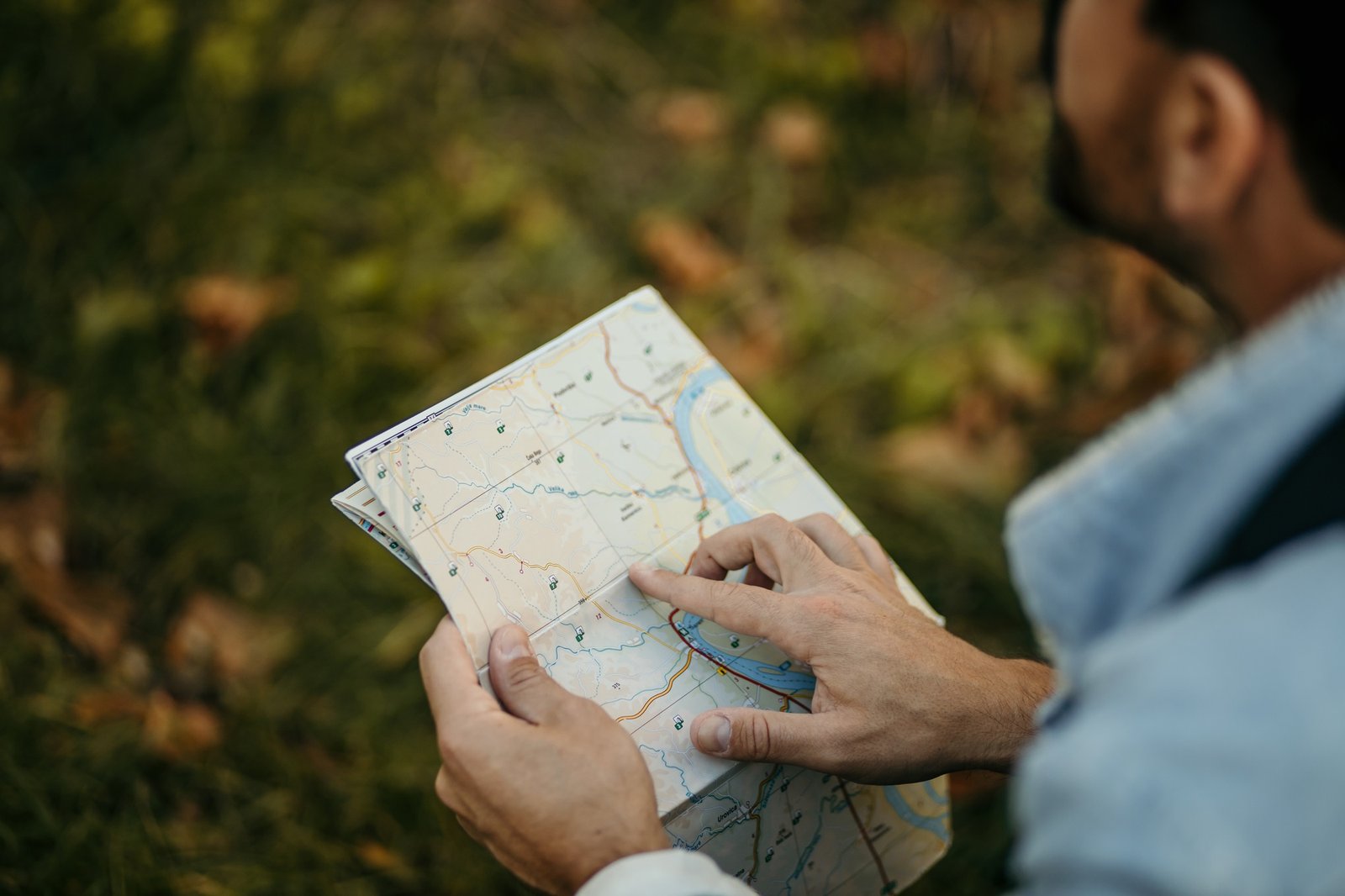 Hiker reading map for orientation during hiking trip